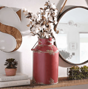 I love vintage milk jugs. They can be used for so many interior design purposes. I love throwing some greenery or cotton blossoms in it and displaying it next to my farmhouse mantel.