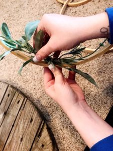 I love this Spring Wreath. It's the cutest embroidery hoop wreath wall hanging. The greenery and floral on it adds so much character. This new trend is so fun. This is such an easy Spring home decor project. You will love making your own diy spring wreath. It's affordable and barely costs anything. #diyhoopwreath #diyembroideryhoopwreath #embroideryhoopwreath #diyspringwreath