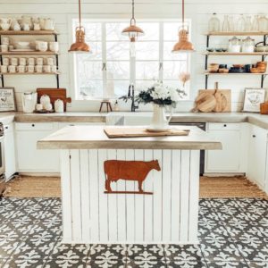 White kitchen with rustic wood open shelving and white dishes.