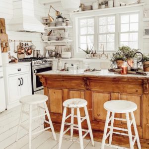 Shiplap kitchen with open shelves and wood island.