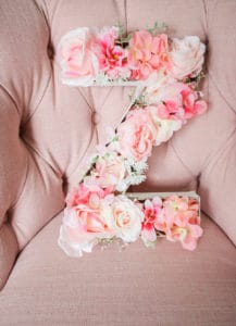 pink flowers in cardboard letter